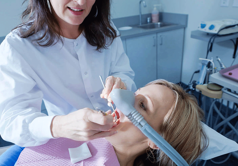 Hygienist administering dental sedation.