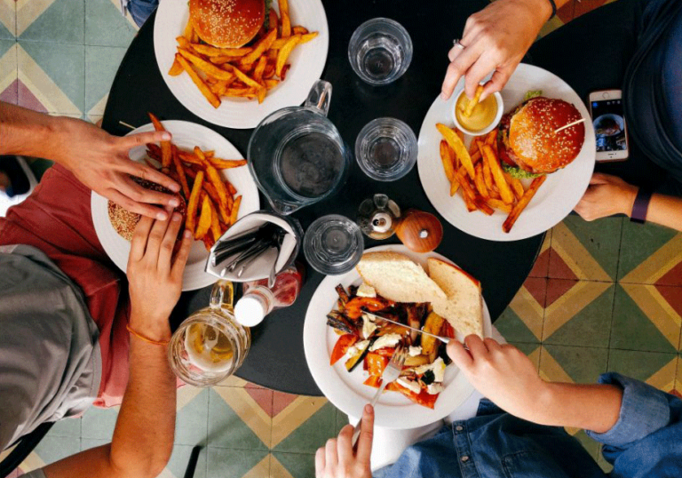 People gathered around a table of food