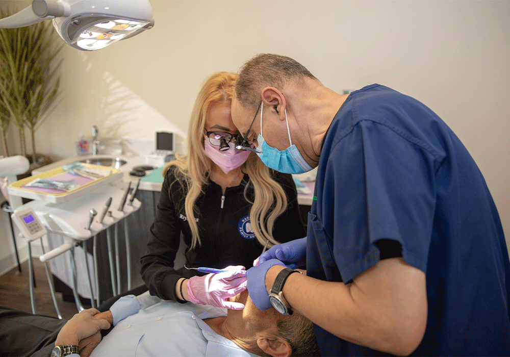 Dr. Radwan and a hygienist working on a patient