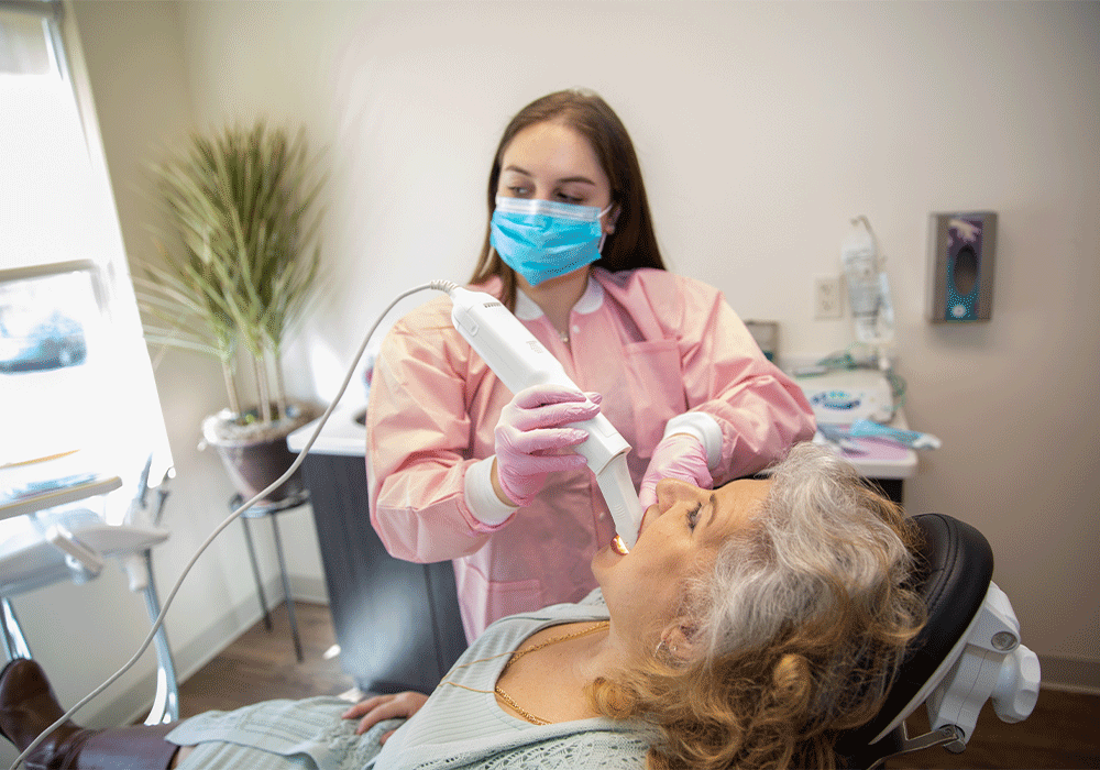 Hygienist using the iTero Scanner on a patient